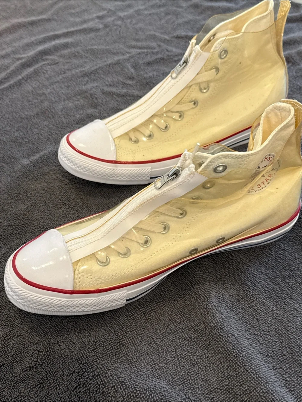 Converse white High Top Sneakers with vinyl zip cover.